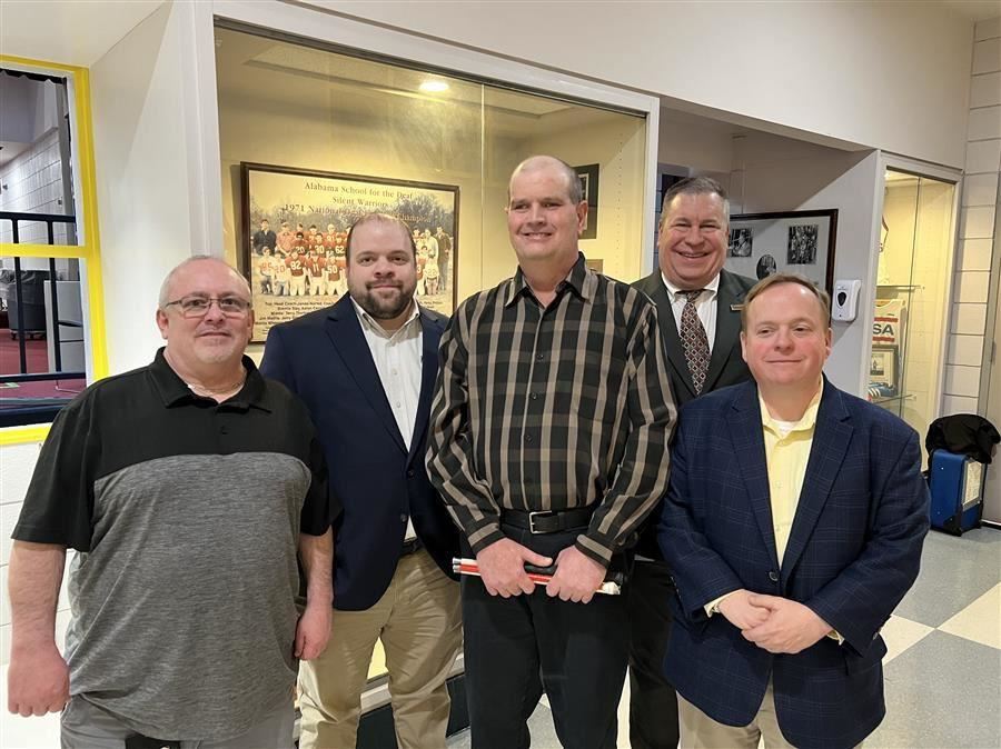  Michael Taylor smiles to camera with four other reps from Alabama Industries for the Blind.